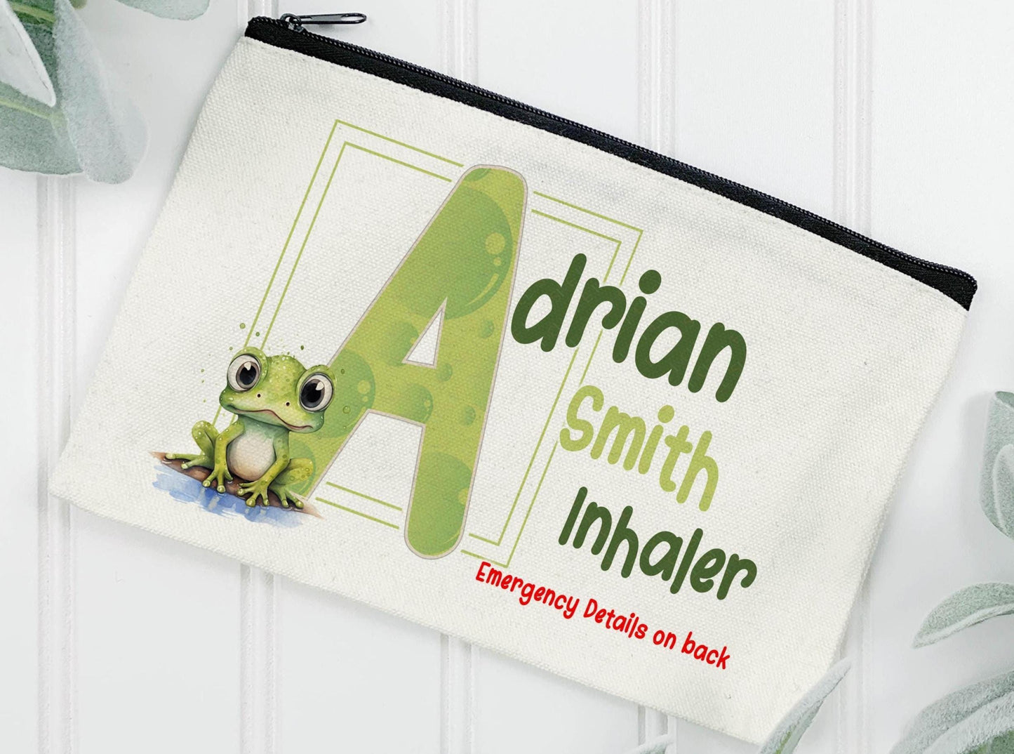 Cream Linen pouch with black zipper with my popular Frog sitting at the edge of a puddle of water & a green initial with bubble design inside the letter. Image above reads Adrian Smith Inhaler Emergency details on back. But can be changed to EpiPen, Medication etc