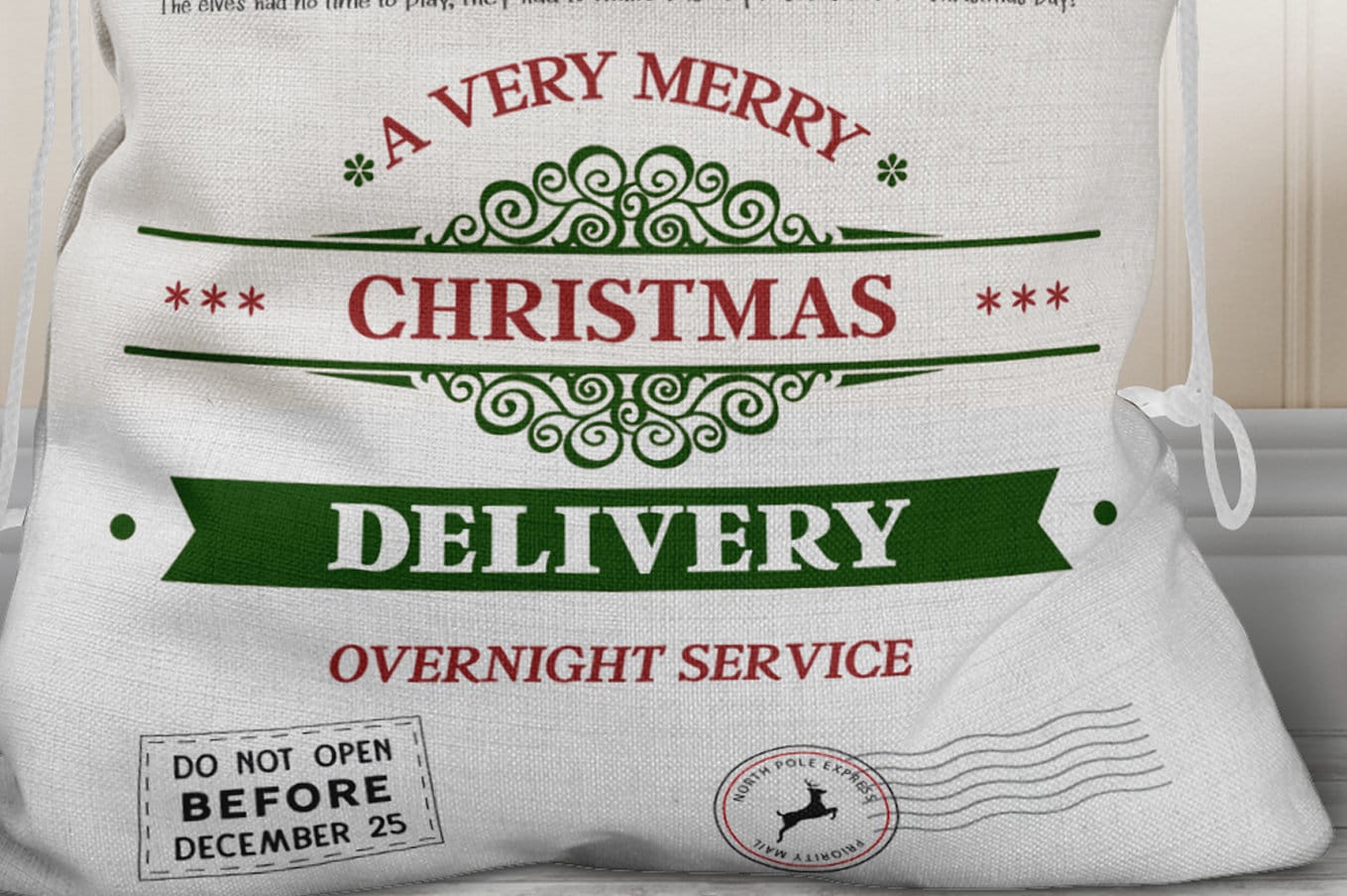 Close up of lower half of Large linen sack with red drawstring and red and green print

Text reads 
A very Merry Christmas delivery Overnight service
Finished off with Christmas stamps