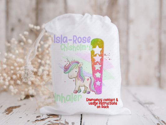 White drawstring bag with Magical Unicorn and initial letter in rainbow glitter colours. Bag shows Initial of first name and a character with text reading name inhaler if you choose to have emergency contact on back it will state this is available on the front.
