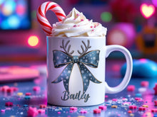 Load image into Gallery viewer, White Ceramic mug printed with a Festive Blue &amp; Gold bow. Topped with Glittery Reindeer Antlers with matching Name. Personalised with any name and printed on both sides. Bows also available in Green, Navy, Red and Pink
