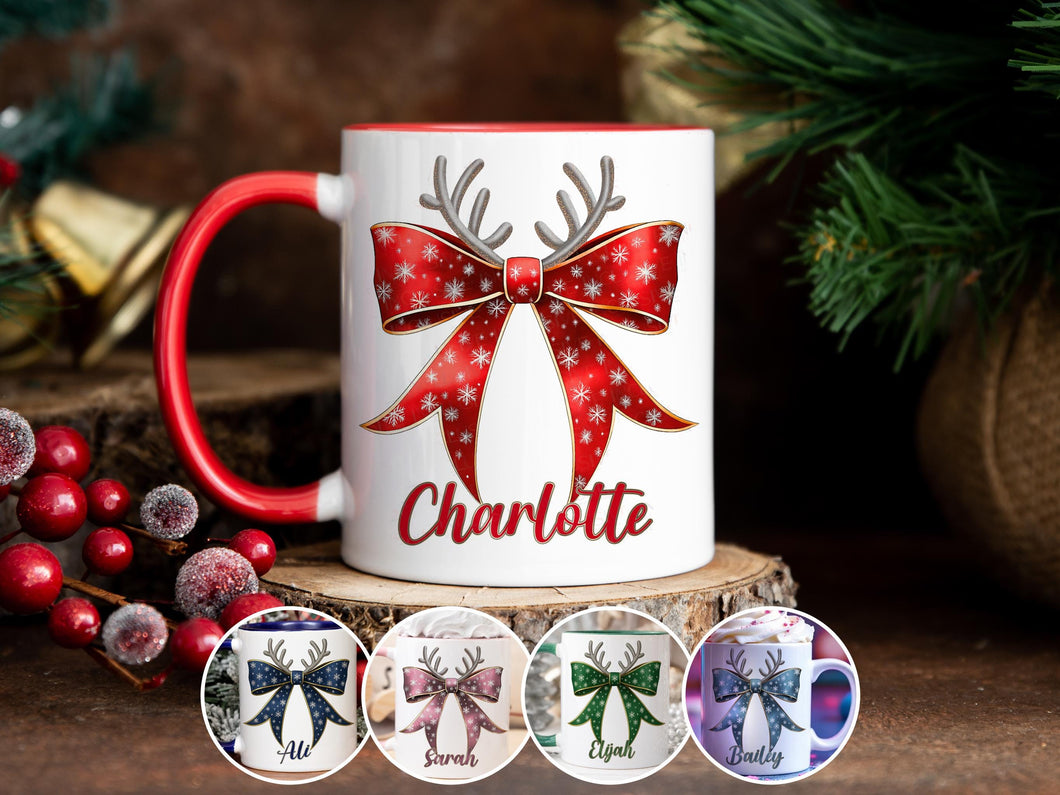 White Ceramic mug with a red rim and handle printed with a Festive Red & Gold bow. Topped with Glittery Reindeer Antlers with matching Name. Personalised with any name and printed on both sides. Bows also available in Green, Dark blue, Light Blue and Pink