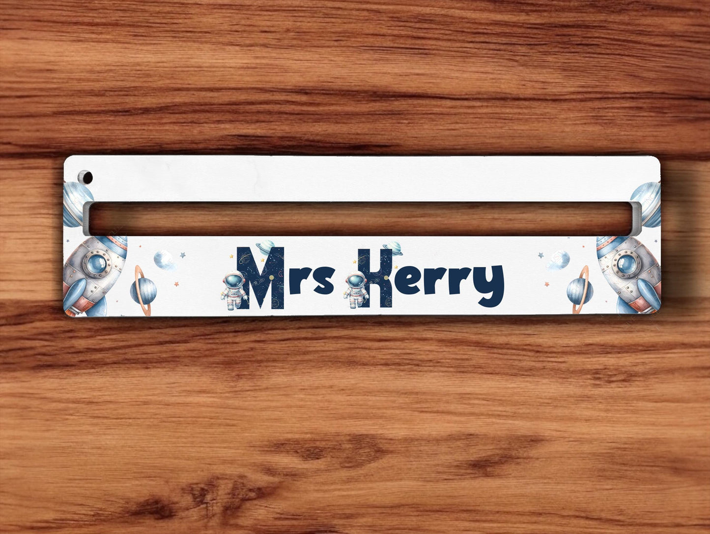 Cute spacemen stand alongside the first letter of each name. Inside the letter is printed with space doodles  of constellations and planets and therest finished in a matching night sky blue. This images show it without the optional ruler print