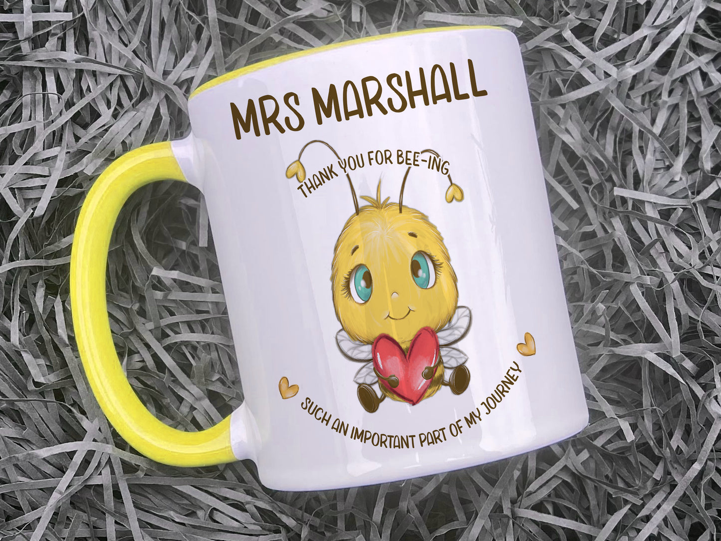 Ceramic mug with yellow handle and rim. A cute cartoon style bee holding a heart sits in the centre of the mug with the words Thank you for bee-ing such an important part of my journey and personalised with any name.