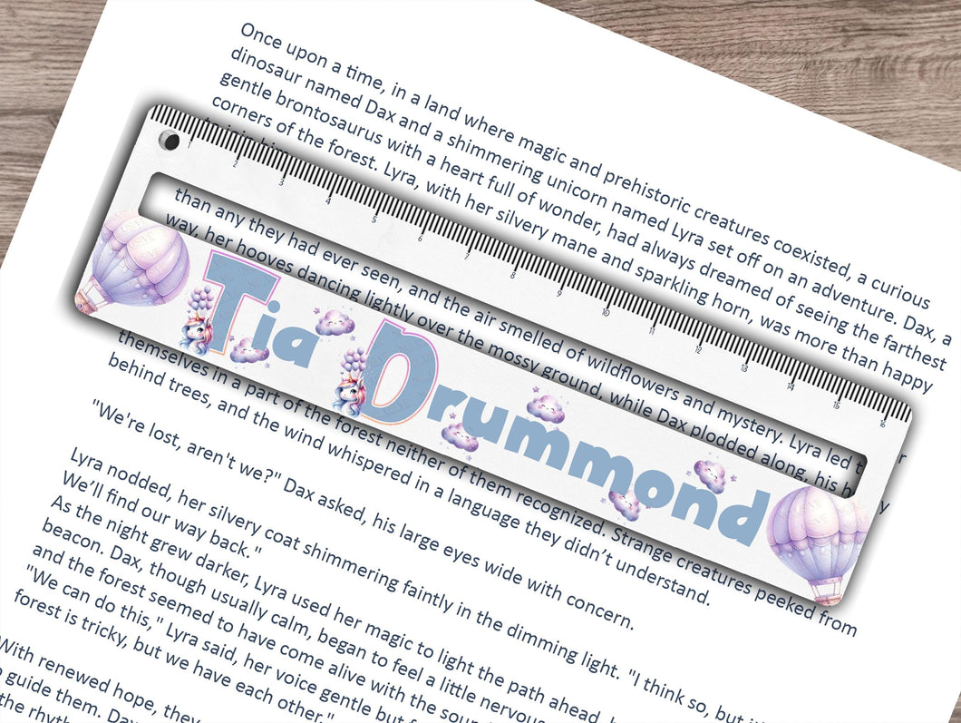 Dyslexia friendly reading ruler printed with a fun unicorn themed print thats personalised with any name. Balloons, clouds and cute Unicorn initials for the name make this a truely exciting and helpful aid Perfect for those with dyslexia, adhd or autism, helping to focus on smaller sections of text, preventing them from losing their place on the page and improving reading comprehension all whilst reducing stress. An optional 16.5cm ruler print at the top adds an extra use to the tool