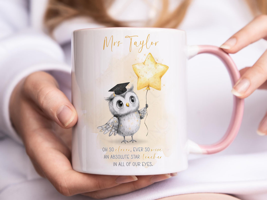 A white mug with lighter pink rim and handle. An adorable owl with a teacher cap holding a gold balloon design and Grey and gold verse is printed directly on the mug so will not fade. Available with or without personalisation.
Verse reads 
Name. 
Oh so clever, ever so wise 
an absolute star teacher
in all of our eyes.
