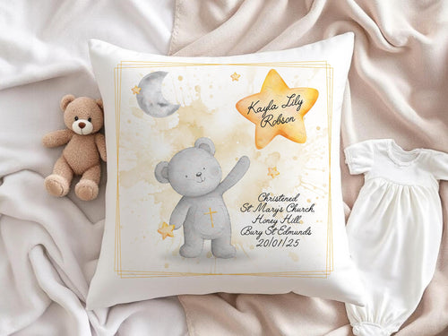 A bright white, 40 x 40cm scatter cushion with a 45cm filler for extra plumpness. Printed with a stunning Baby bear with a small gold cross on his tummy. A soft grey baby bear standing under a grey crescent moon with a small gold star in his right hand and reaching up with his  left towards a larger Gold star with Name of your choice. The image is gently framed in a simple soft yellow frame. Choice of baptism or christening, place and date are printed on thelower right corner in a black script