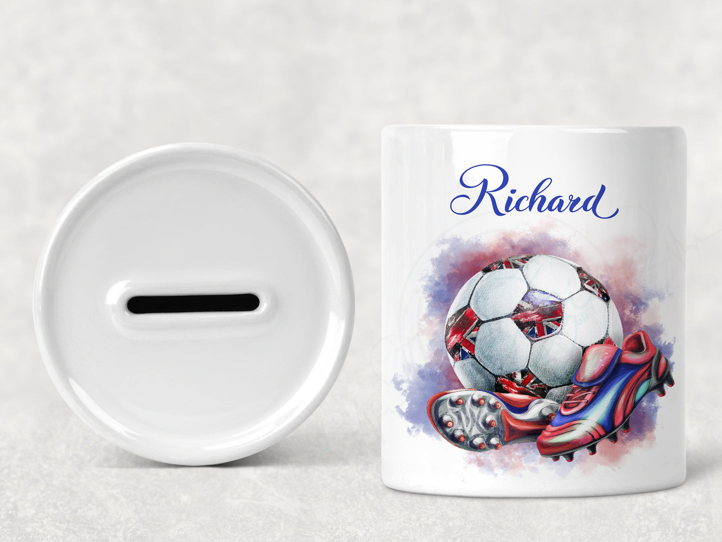 Bright white round ceramic money box with red white and blue coloured football with union jack patches and red and blue boots. Personalised with any name in matching blue text.
