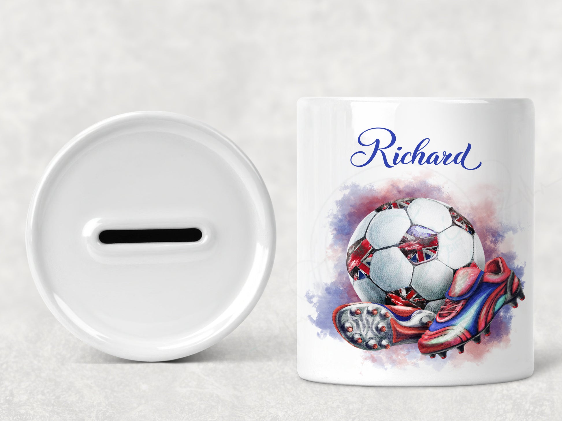 Bright white round ceramic money box with red white and blue coloured football with union jack patches and red and blue boots. Personalised with any name in matching blue text.