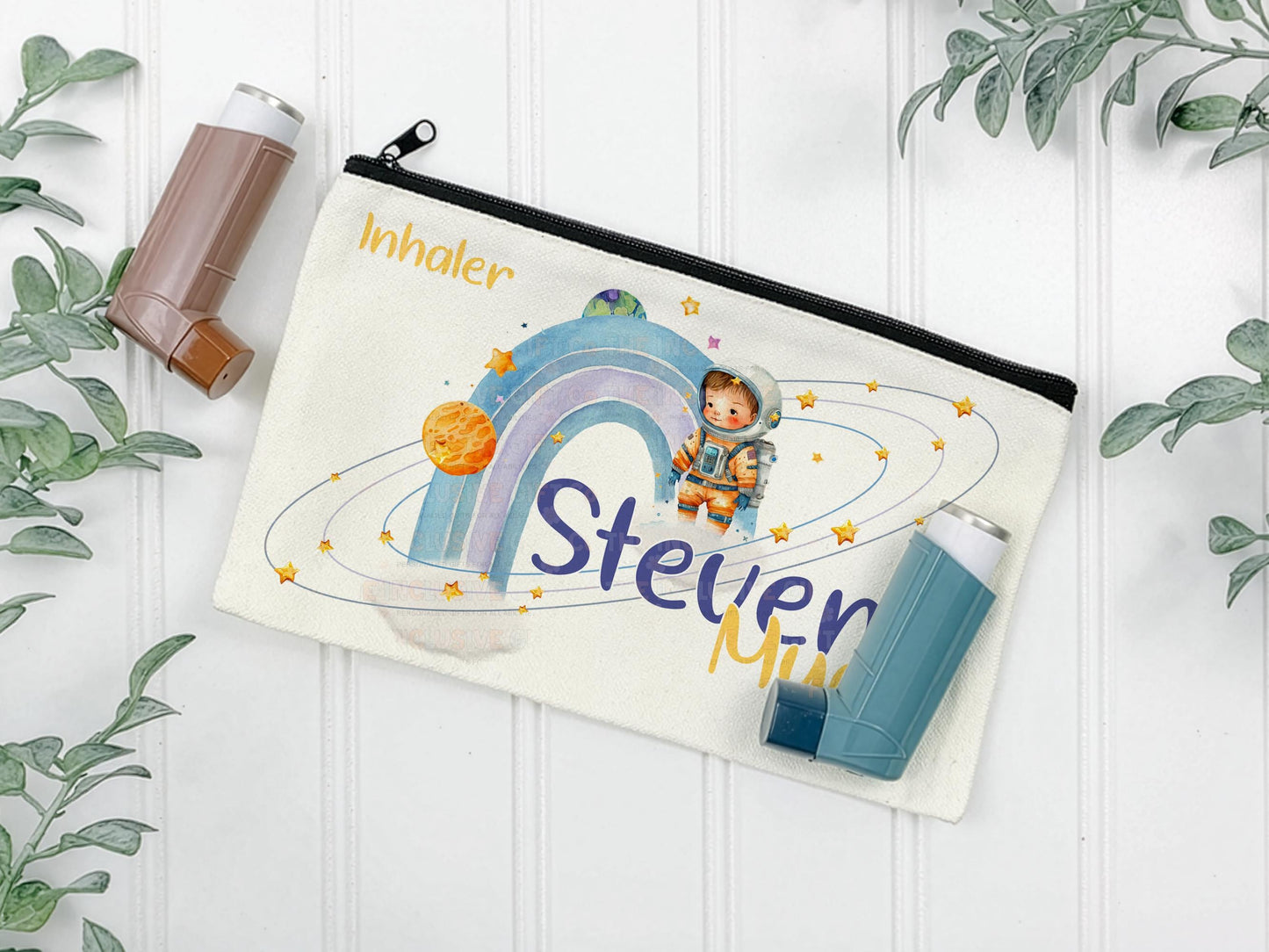 Offwhite canvas pouch for storing Asthma inhalers. Black zipper allows for secure closing. The design features a watercolor illustration of an astronaut, planets, stars, and a rainbow. Text includes "Inhaler"