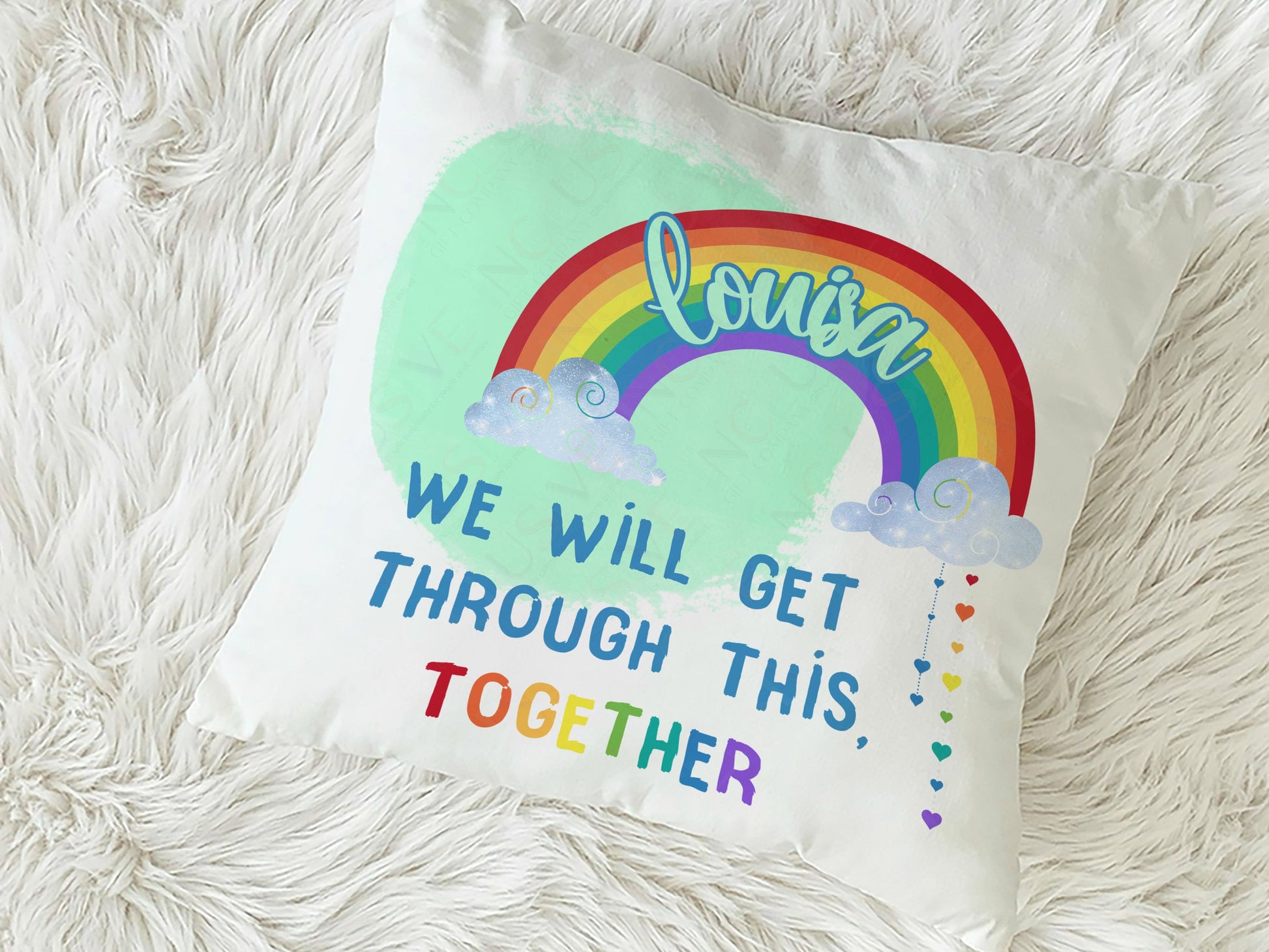 Plush white Cushion with vibrant printed rainbow and clouds with words we will get throughthis together. Add a name to the rainbow to personalise.