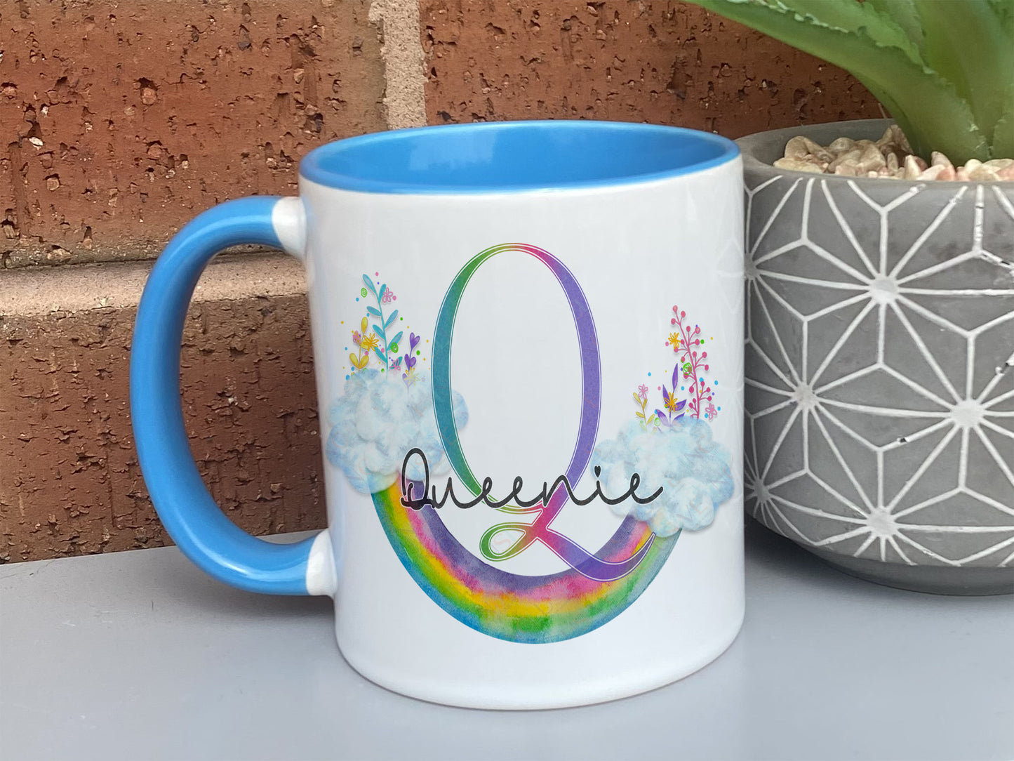 White with blue handle and rim ceramic mug with floral Upside down floral watercolour rainbow and matching initial and name.