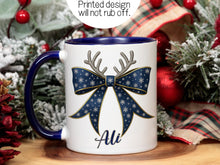 Load image into Gallery viewer, White Ceramic mug with a Navy rim and handle printed with a Festive Navy &amp; Gold bow. Topped with Glittery Reindeer Antlers with matching Name. Personalised with any name and printed on both sides. Bows also available in Green, Red, Light Blue and Pink.

Printed design wont rub off.
