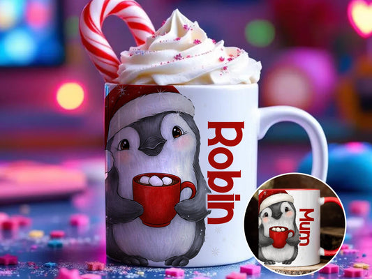 Ceramic mug printed with a cheerful little Penguin holding a mug of steaming hot chocolate and Marshmallows peeking back at you. His festive red Christmas hat perched cheekily on his head. Personalised with any name and printed on both sides. Available in either plain white mug or a white mug with a festive red rim and handle
