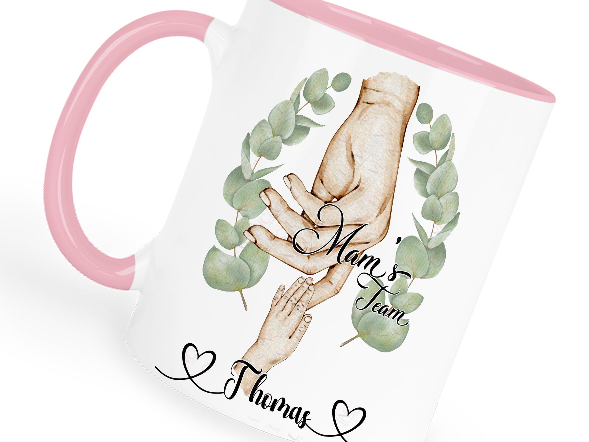 Ceramic mug with pastel pink handle and rim. Printed with watercolour style artwork of adult female hand and childrens hands