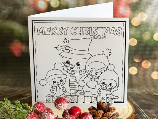 Colour your own White 5x5 inch sq card with black and white line drawing of Cute festive Snowman family Two adult & two small snowkids. Wordings reads Merry Christmas from Name)