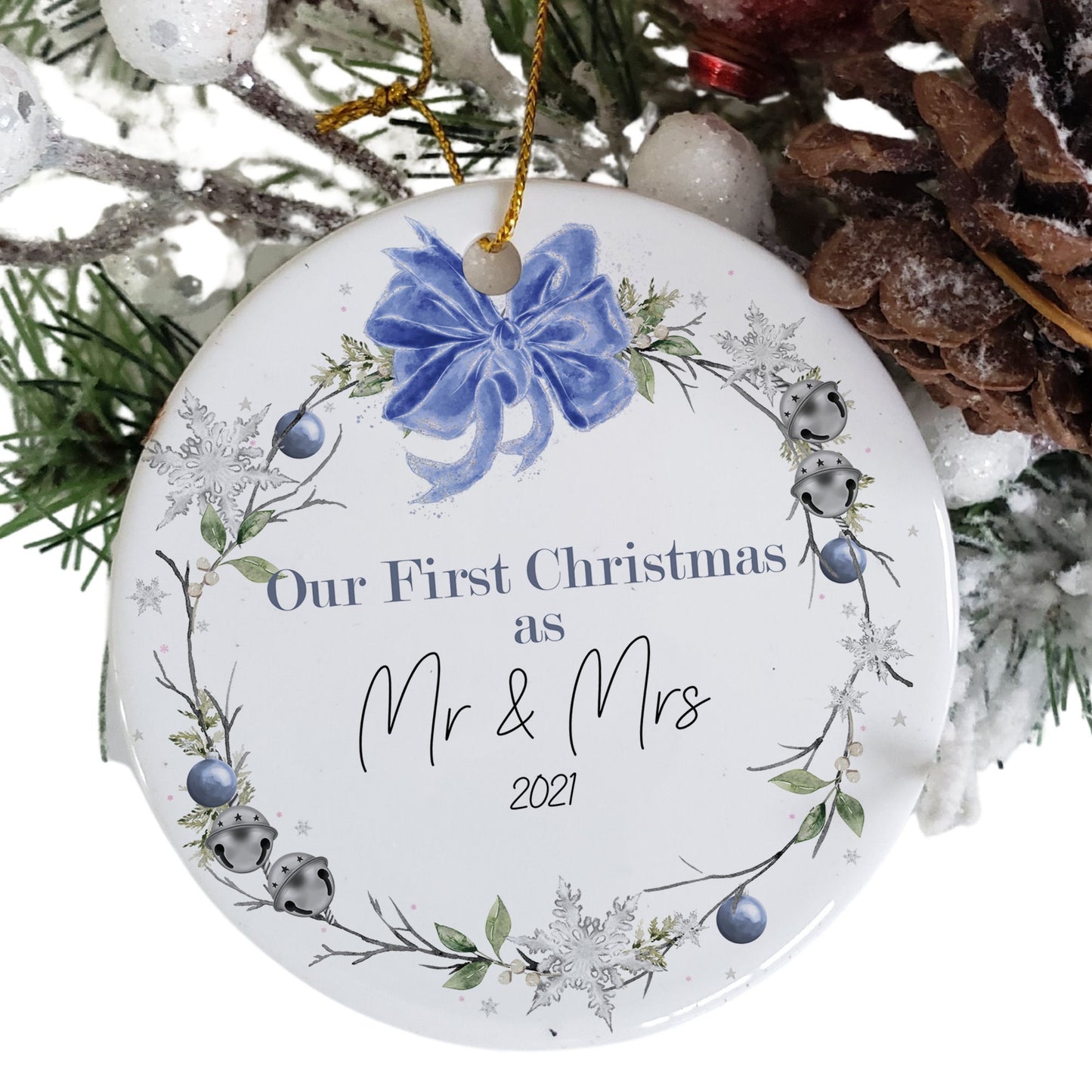 Flat Ceramic white bauble printed with Blue and green floral wreath & sleigh bells topped with a blue bow design Message reads Our First Christmas as Mr & Mrs (year)