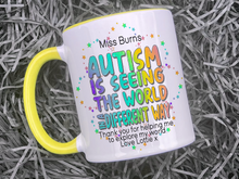 Load image into Gallery viewer, Ceramic mug with yellow handle and rim. Bright colourful rainbow wording reading Teachers name and Autism is seeing the world in a differnt way, thank you for helping me to explore my world love name

