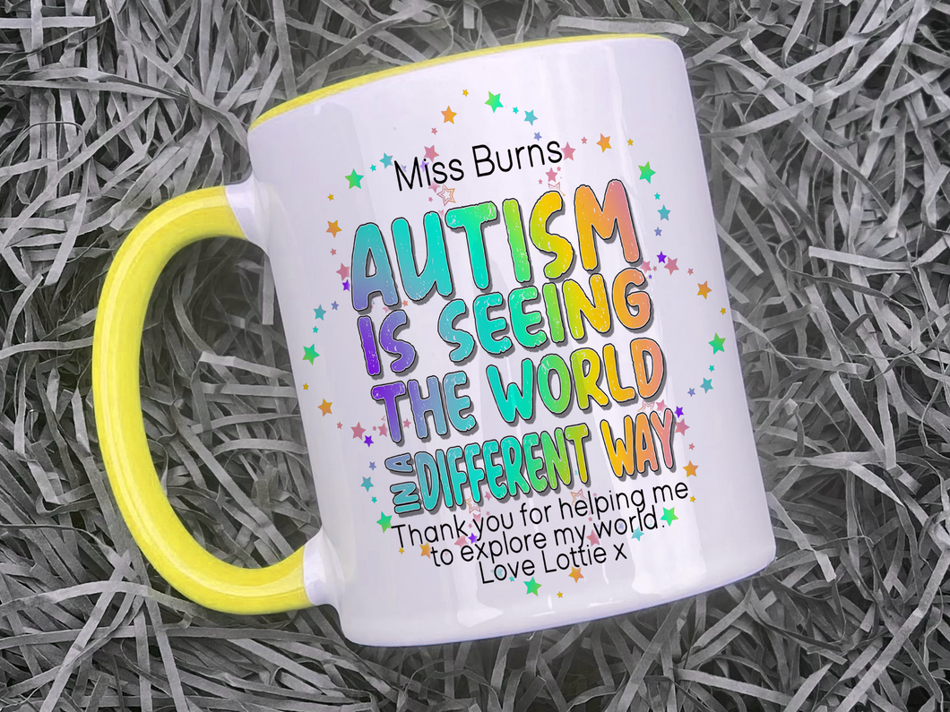 Ceramic mug with yellow handle and rim. Bright colourful rainbow wording reading Teachers name and Autism is seeing the world in a differnt way, thank you for helping me to explore my world love name