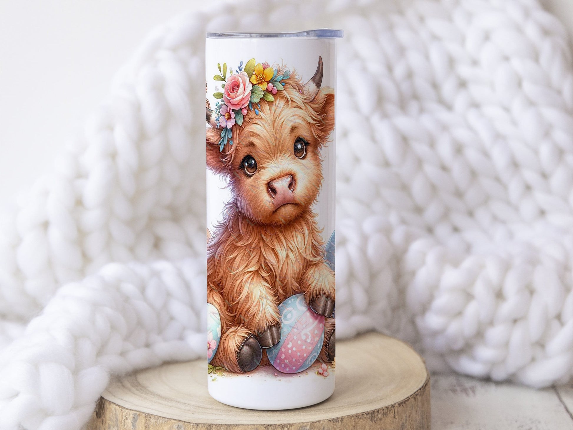20oz white stainless teel tumbler with a realistic baby highland with easter themed eggs. Bright colour flowers complete the design which wraps around the cup. Matching text for name can be added to bottom of tumbler