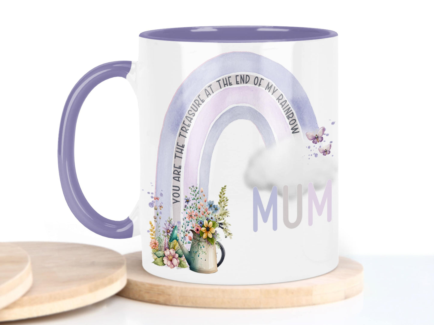 White ceramic mug with glossy purple handle, rim and inner. Design shows A purple and pink coloured rainbow with flowers and watering can at one end, cloud & butterflys at the other. 

Text reads Mum You are the treasure at the end of my rainbow.