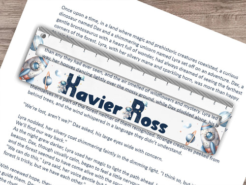 Dyslexia friendly reading ruler printed with a fun space themed print thats personalised with any name. Rocket ships, stars, planets and cute Space men initials for the name make this a truely exciting and helpful aid Perfect for those with dyslexia, adhd or autism, helping to focus on smaller sections of text, preventing them from losing their place on the page and improving reading comprehension all whilst reducing stress. An optional 16.5cm ruler print at the top adds an extra use to the tool