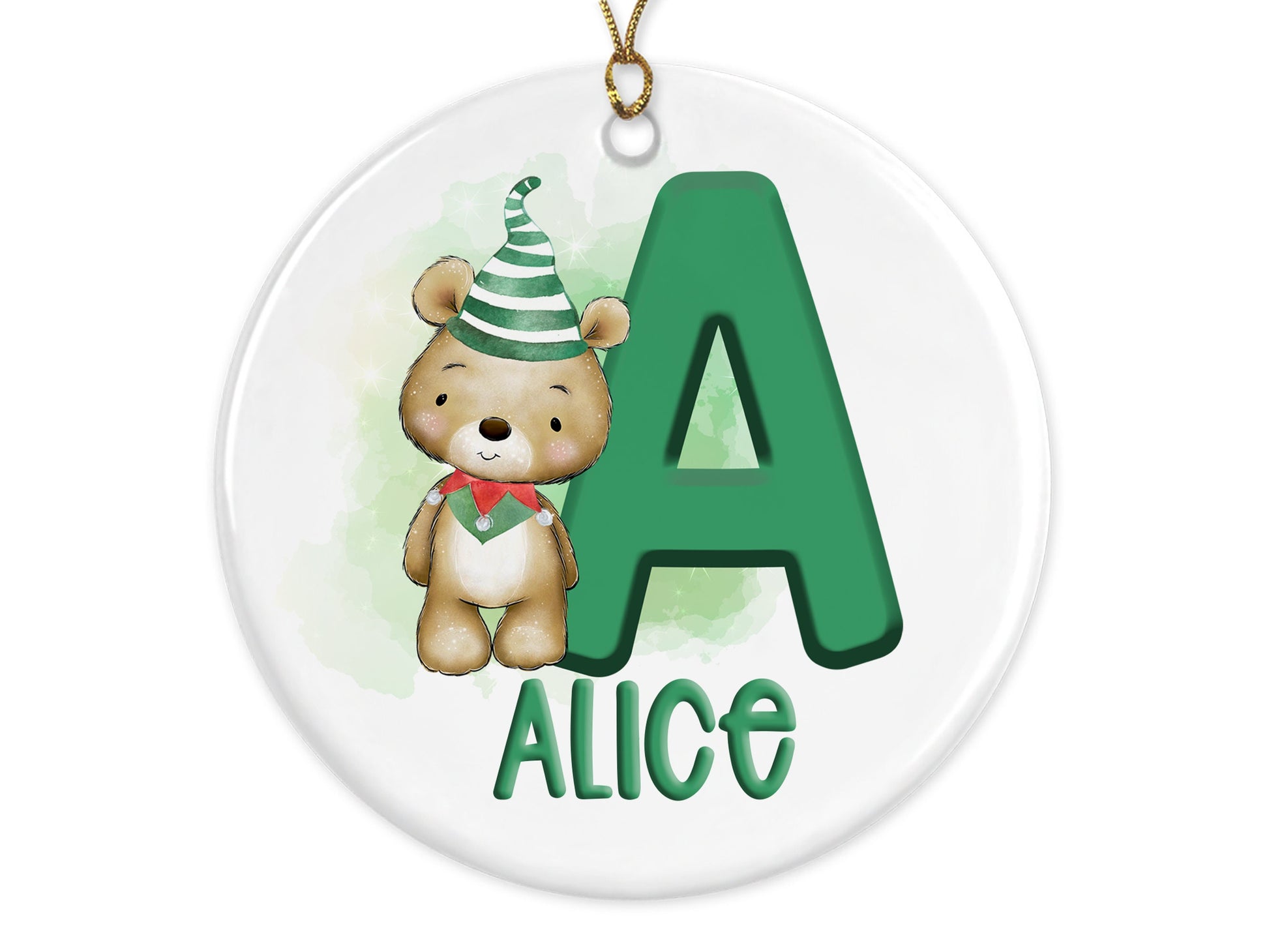 White ceramic bauble with Green letter with Cute brown teddy dressed in green and white striped hat and green and red elf collar.  Name written across the bottom in matching Green with gold cord to hang.