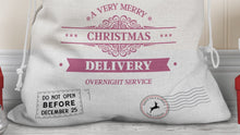 Load image into Gallery viewer, Close up of bottom of sack with words A very merry Christmas Delivery Overnight service and two North pole style delivery stamps one reads do not open before December 25th &amp; the other is a simple round postage stamp with reindeer.
