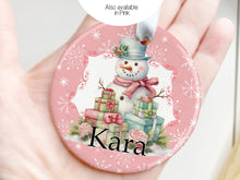 Load image into Gallery viewer, Also available in Pink

Snowman is surrounded by brightly wrapped presents and sits on a pink background with white snowflakes.

