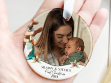 Load image into Gallery viewer, 7cm round ceramic bauble with photo of your choice framed with holly and the text Name&#39;s First Christmas 2023 in black. Perfect for baby on their own or photos of baby with mum dad or other family members
