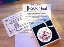 Load image into Gallery viewer, Image shows what to expect in your parcel. 

Ceramic ornament comes with white ribbon attached in a simple square gift box, packing slip, thank you &amp; social media info.
